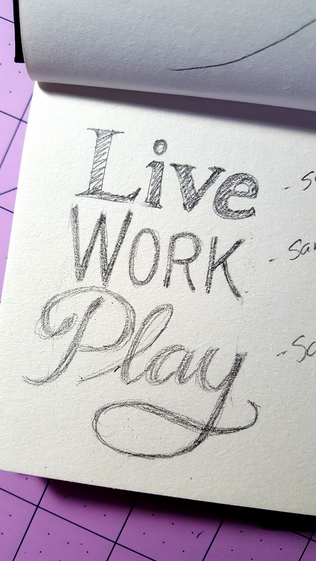 sketchpad with pencil sketch of the words live work play